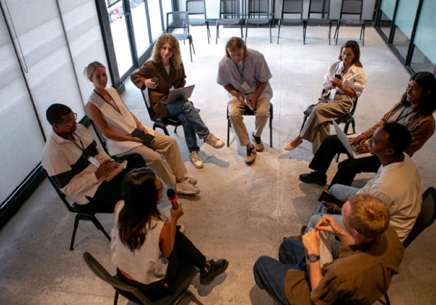 people sitting around in a group circle