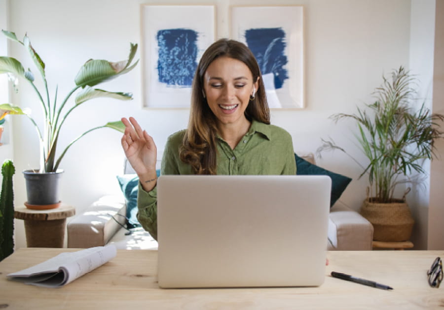 Woman in talking in front of a computer screen