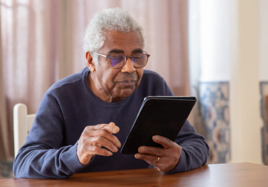 Senior looking at a tablet